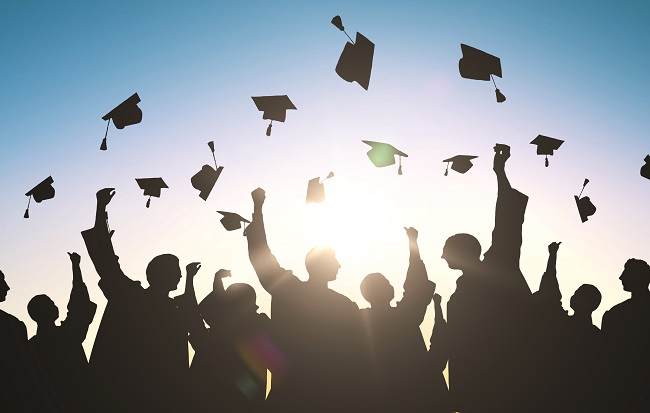 Graduation caps being thrown in the air