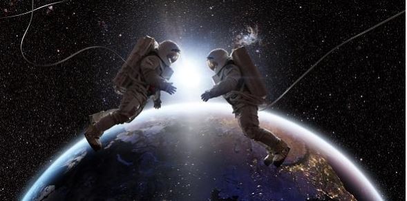 Two astronauts floating in space, facing each other.