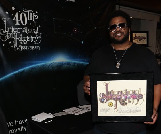 Craig Robinson holding his name a star certificate from starregistry.com
