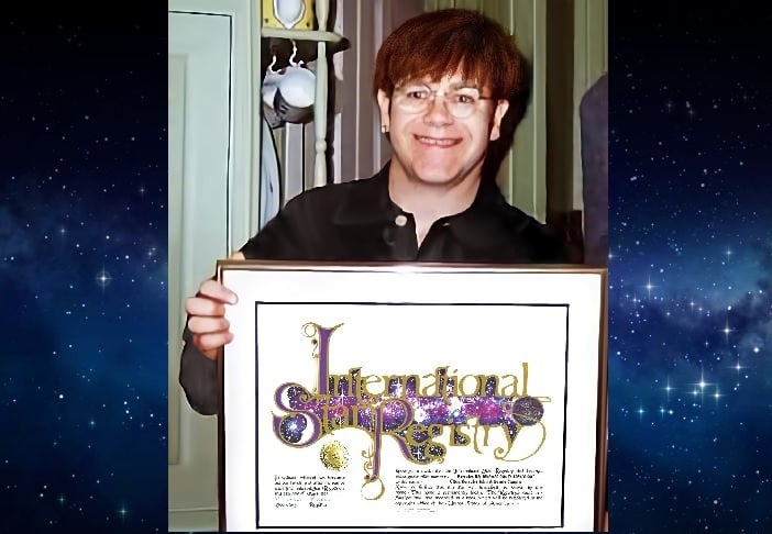 Sir Elton John holding his name a star certificate from starregistry.com
