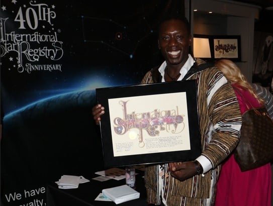 Hakeem Kae-Kazim holding his name a star certificate from starregistry.com