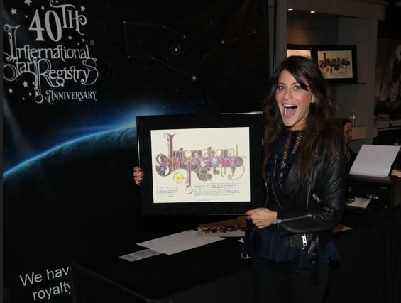 Jackie Tohn holding her name a star certificate from starregistry.com