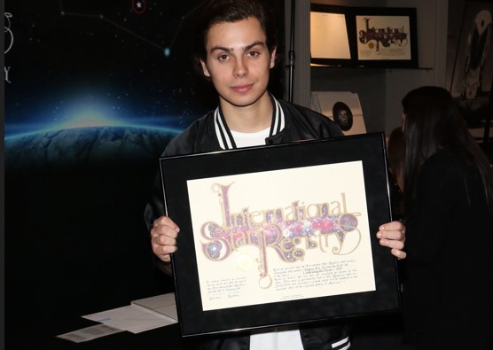 Jake T Austin holding his name a star certificate from starregistry.com