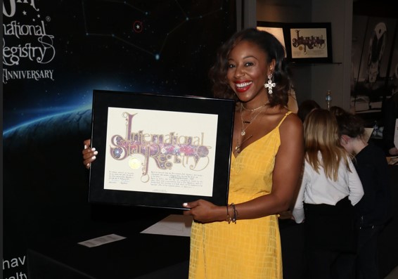 Kinya Claiborne holding her name a star certificate from starregistry.com