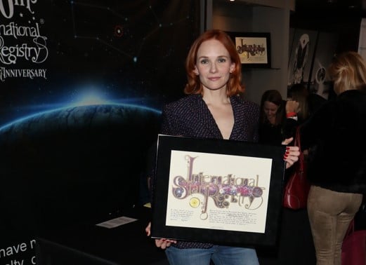 Marianne Farley holding her name a star certificate from starregistry.com