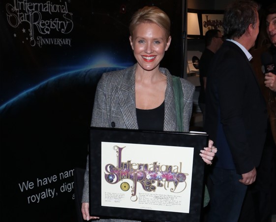 Nicky Whelan holding her name a star certificate from starregistry.com