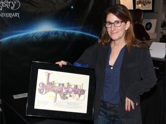 Nicole Holofcener holding her name a star certificate from starregistry.com