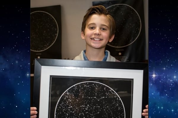 Parker Bates holding a sky map from International Star Registry