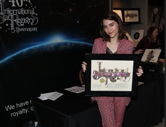 Quinn Shephard holding her name a star certificate from starregistry.com