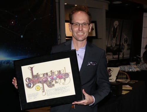 Skye Fitzgerald holding his name a star certificate from starregistry.com