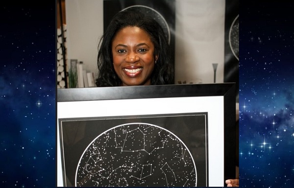 Sope Aluko holding a sky map from International Star Registry