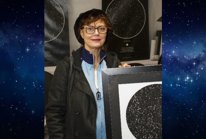 Susan Sarandon holding a sky map from International Star Registry