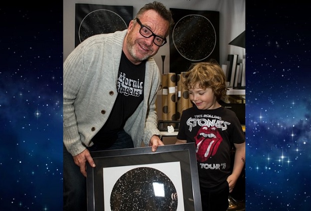 Tom Arnold holding a sky map from International Star Registry