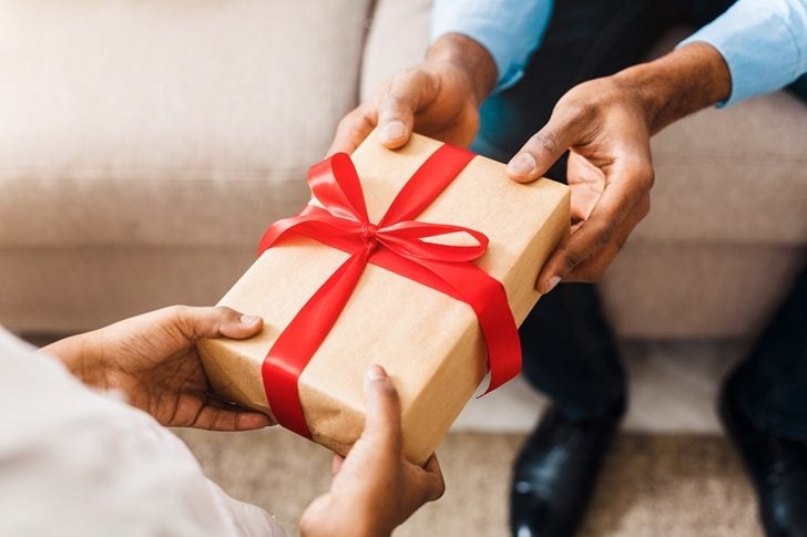 Father,Hands,Giving,Birthday,Gift,To,Daughter,,Closeup