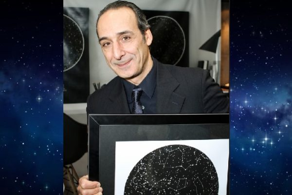 Alexandre Desplat holding a sky map from International Star Registry