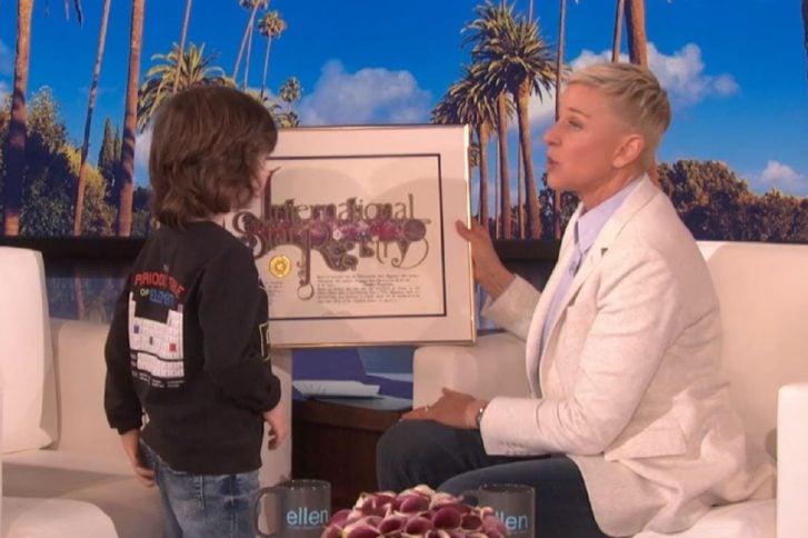 Ellen DeGeneres giving a Star Registry package to young guest live on her show.