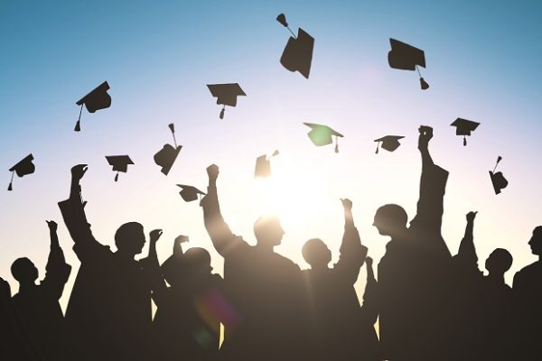 Graduation caps being thrown in the air