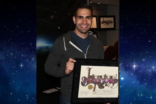 Joseph Yomtoubian holding his name a star certificate from starregistry.com