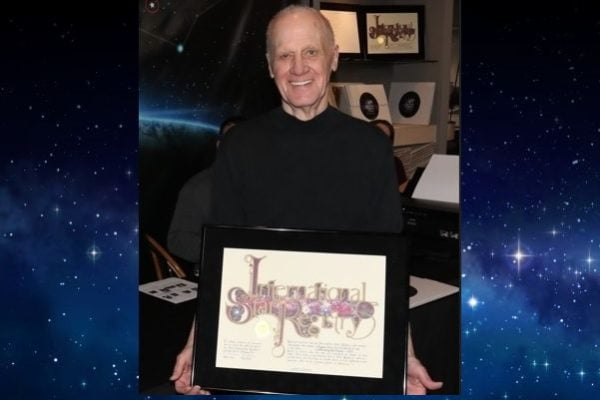Leon Russom holding his name a star certificate from starregistry.com