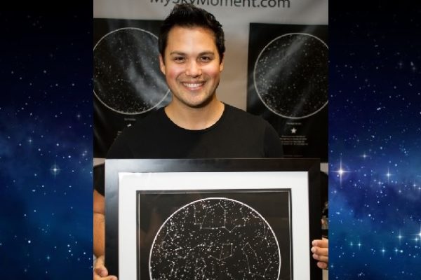 Michael Copon holding a sky map from International Star Registry
