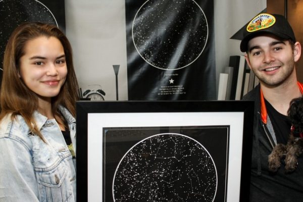 Paris Berelc holding a sky map from International Star Registry