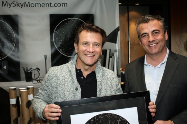 Robert Herjavec holding a sky map from International Star Registry