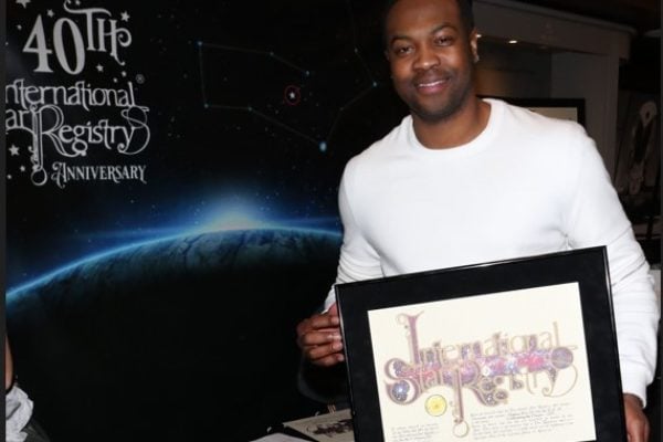 Ser'Darius Blain holding his name a star certificate from starregistry.com