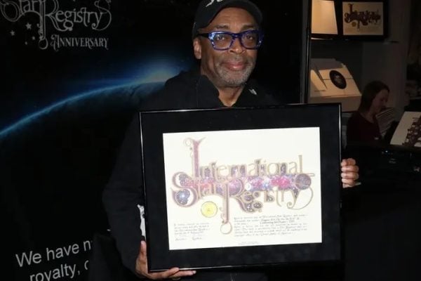 Spike Lee holding his name a star certificate from starregistry.com