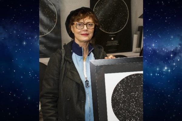 Susan Sarandon holding a sky map from International Star Registry