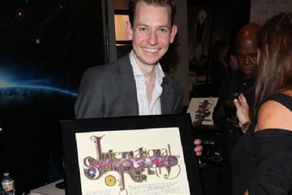 Vincent Lambe holding his name a star certificate from starregistry.com