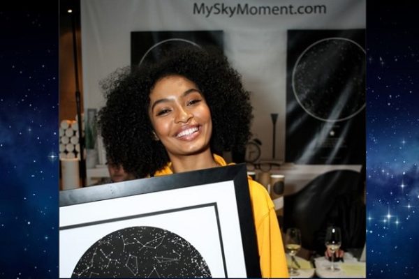 Yara Shahidi holding a sky map from International Star Registry